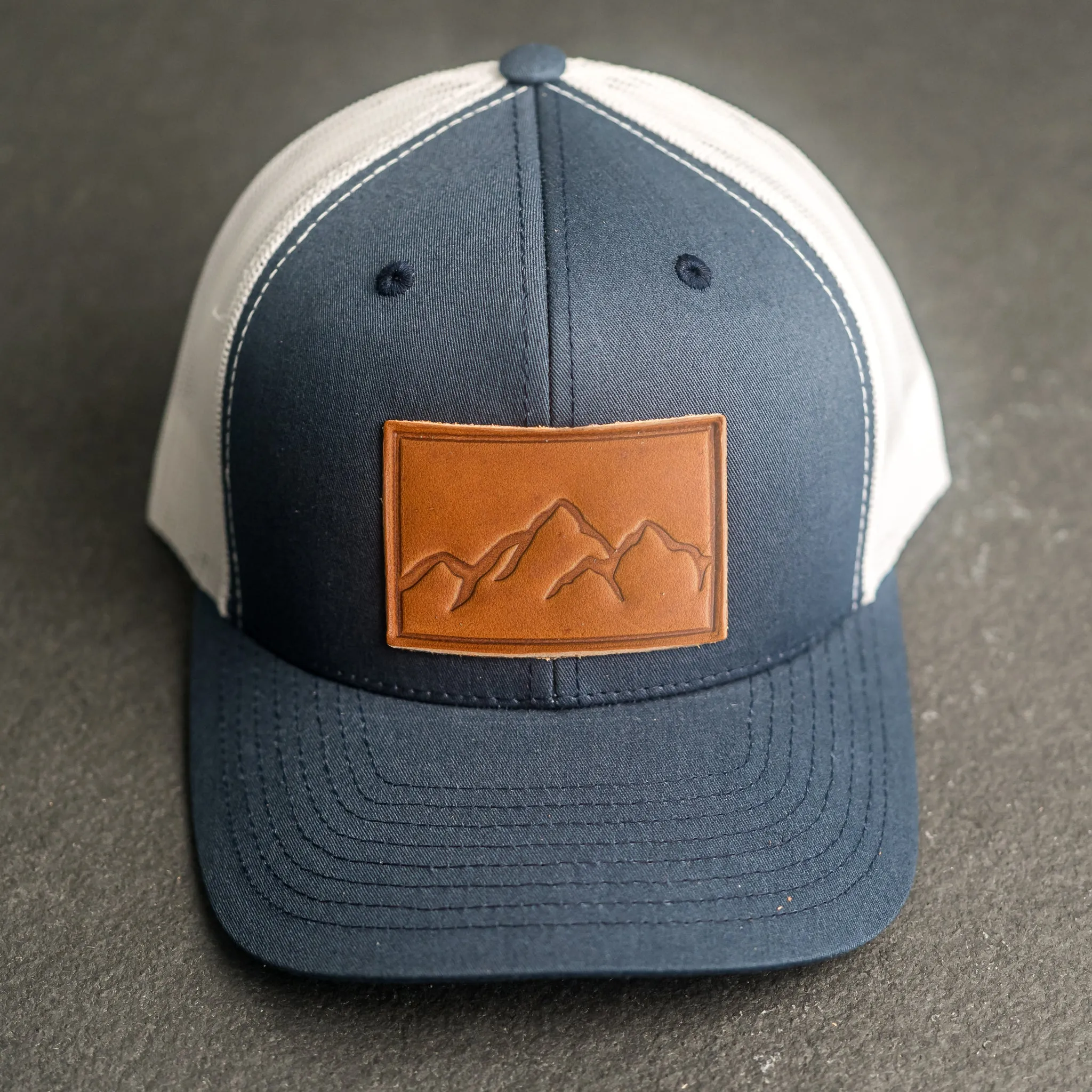 Leather Patch Trucker Style Hat - Mountain Range Stamp