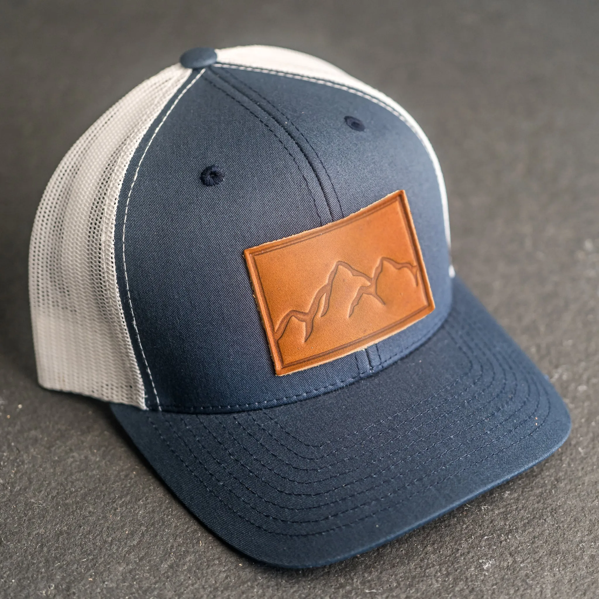 Leather Patch Trucker Style Hat - Mountain Range Stamp