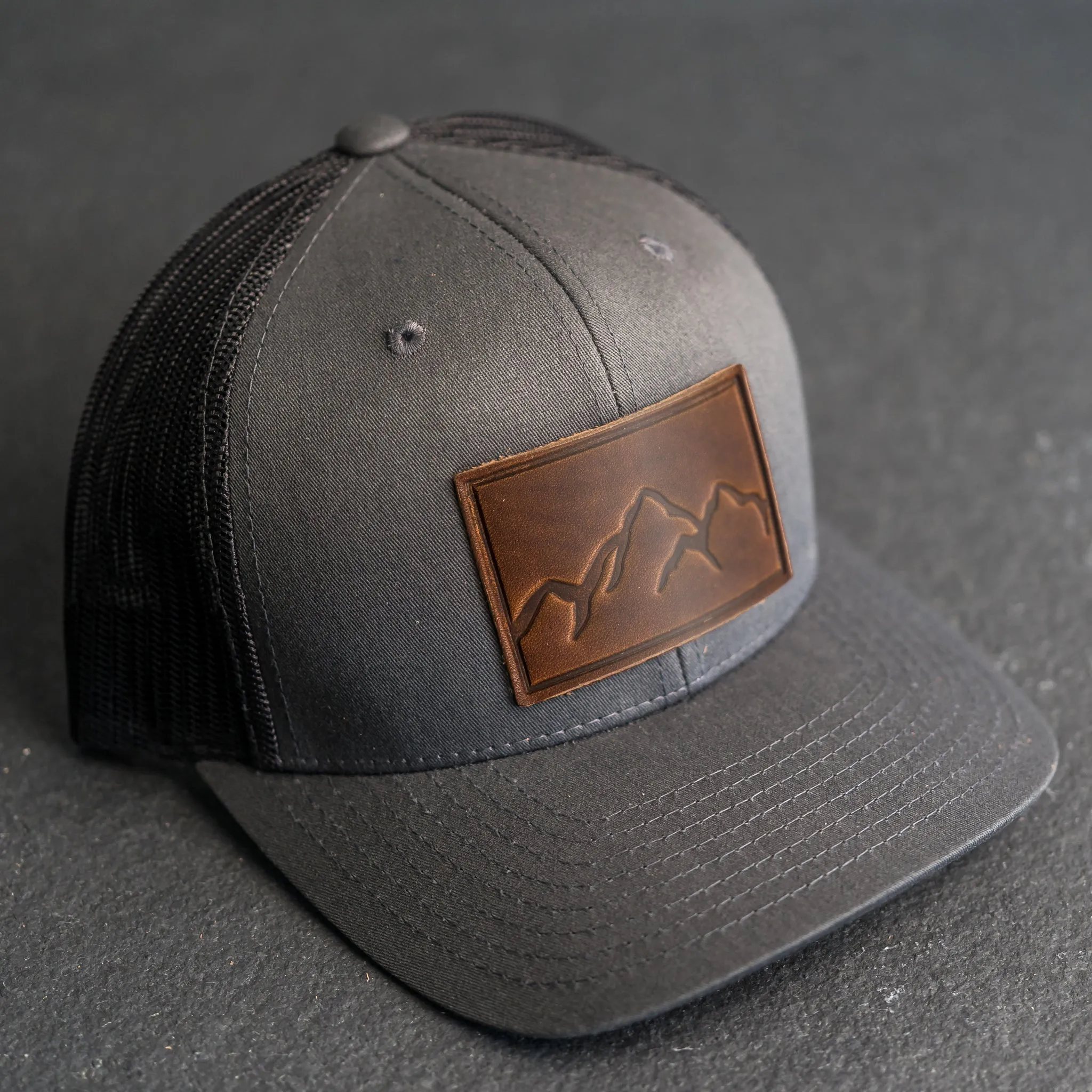 Leather Patch Trucker Style Hat - Mountain Range Stamp