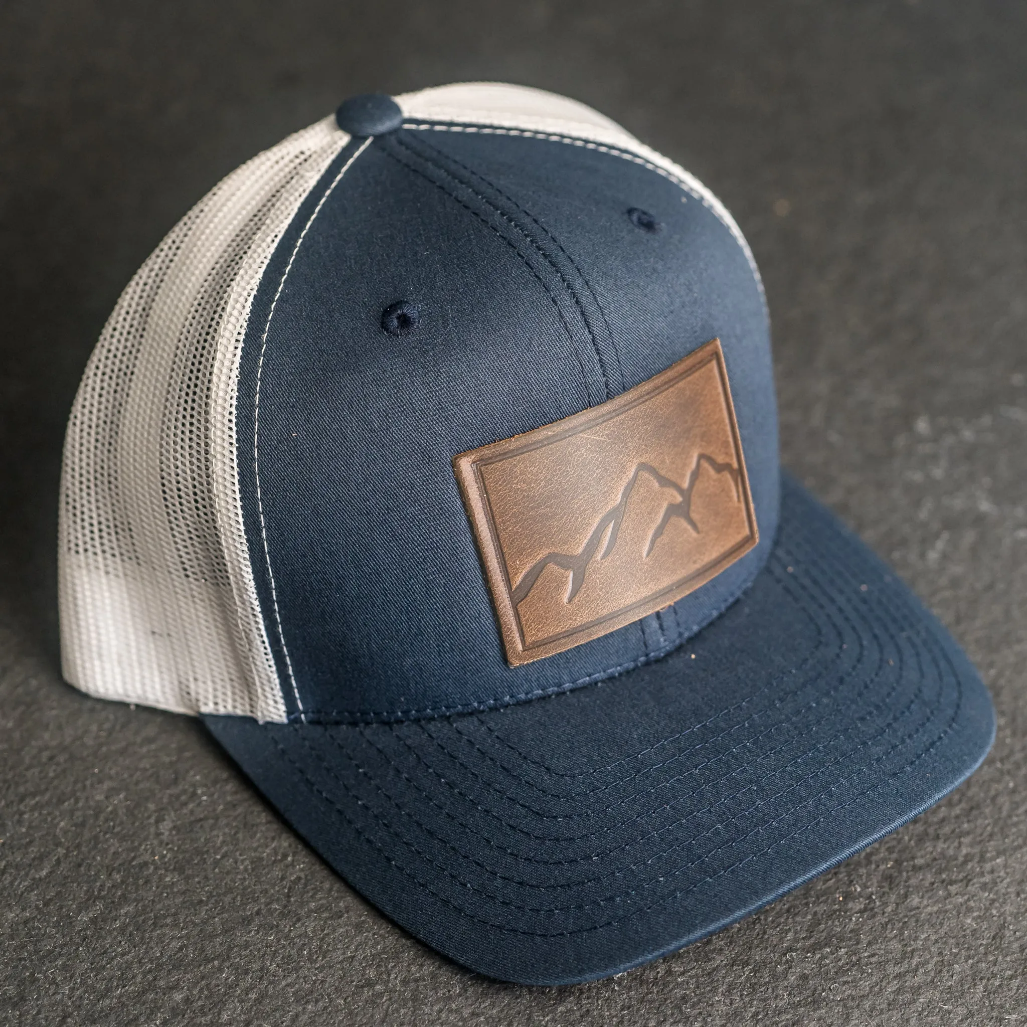 Leather Patch Trucker Style Hat - Mountain Range Stamp