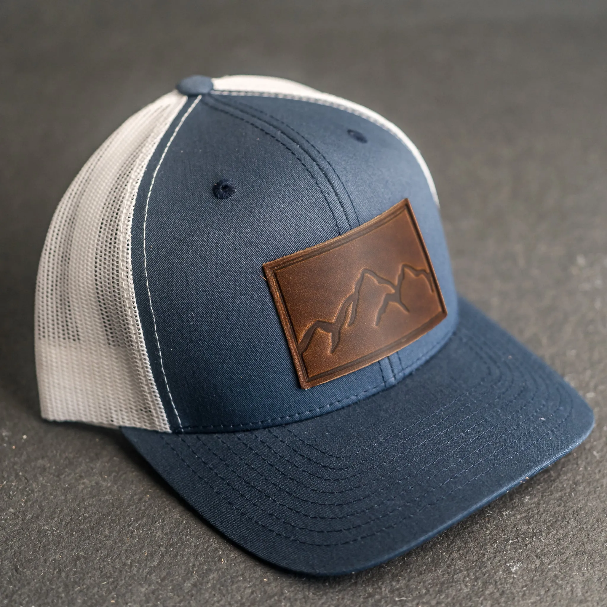 Leather Patch Trucker Style Hat - Mountain Range Stamp